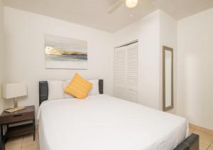 a white bedroom with a bed and a window at Hollywood private apartments in Hollywood