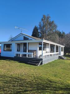 a large white house with a large yard at Ruapehu Farm Chalet in Ohakune