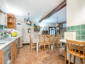 a kitchen and dining room with a table and chairs at Berwyn Bank in Gilcrux