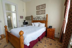 a bedroom with a large bed and a window at Jackson House Hotel in Eureka