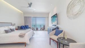 a bedroom with a bed and a view of the ocean at Sonoran Star Signature 3-Bedroom Beachfront Luxury Condominium in Puerto Peñasco +16 photos