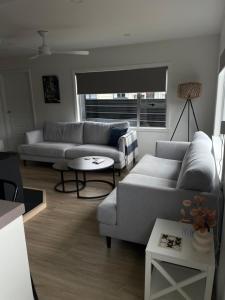 a living room with two couches and a table at Relax at Jollie-Cozy 3-Bedroom Home, Central Twizel in Twizel