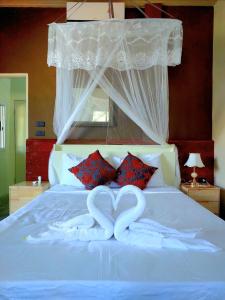 two heart shaped towels on top of a bed at Tha Khao Beach House 1 in Ban Bang Chak