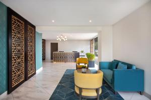 a lobby with a blue couch and a yellow chair at Swiss-Belhotel Napier in Napier