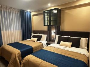 a room with two beds in a room at Gran Hotel in Yungay