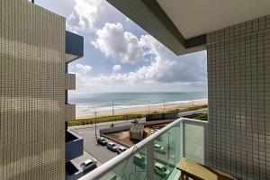 a view of the beach from the balcony of a building at RN Studio Premium – Your Seaside Retreat in Maceió