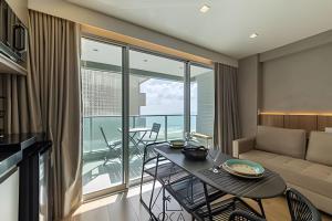 a living room with a table and a couch at RN Studio Premium – Your Seaside Retreat in Maceió
