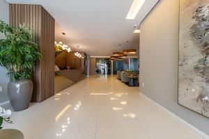 an office lobby with a plant in a vase at RN Studio Premium – Your Seaside Retreat in Maceió +42 photos