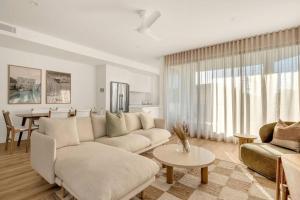 a living room with a couch and a table at Salt Tugun in Gold Coast