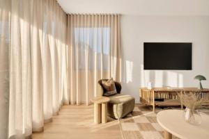 a living room with a chair and a table at Salt Tugun in Gold Coast