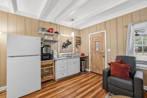 a kitchen with a refrigerator and a chair in a room at Spacious comfortable Studio Unit in Tallahassee