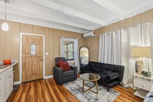 a living room with a couch and a table at Spacious comfortable Studio Unit in Tallahassee