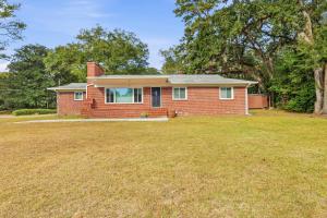 a red brick house with a large yard at Spacious comfortable Studio Unit in Tallahassee
