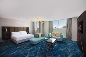 a hotel room with a bed and a couch at Swiss-Belhotel Napier in Napier