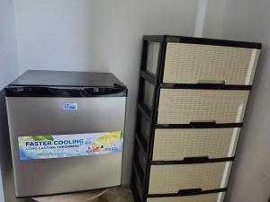 a refrigerator sitting next to a stack of shelves at Double bed room in Santo Domingo