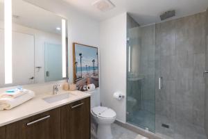 a bathroom with a shower and a toilet and a sink at Downtown Skyline Heights with Stunning Ocean View in Miami +11 photos
