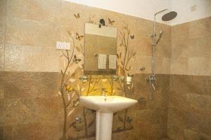 a bathroom with a sink and a shower with a mirror at Orange Jesmine Unawatuna in Unawatuna +94 photos