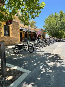 a row of motorcycles parked in front of a store at Mount Pleasant Hotel in Mount Pleasant