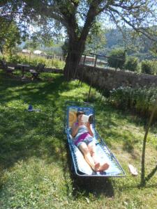 a woman is laying on a inflatable at Gîtes des Gabriels in La Chapelle-en-Vercors