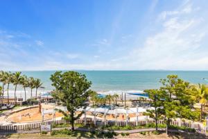 an aerial view of a beach with palm trees and the ocean at Echelon Apartments Yeppoon in Yeppoon