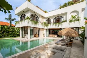 an exterior view of a house with a swimming pool at Sapta Cemagi - Villa Deluna in Cemagi