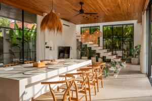 a large dining room with a long table and chairs at Sapta Cemagi - Villa Deluna in Cemagi