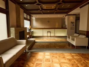 a living room with two couches and a kitchen at Nikko Station Hotel Classic in Nikko