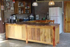 a kitchen with a wooden counter and a refrigerator at little Island in Na Lúng +17 photos