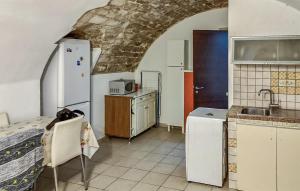 a kitchen with a sink and a refrigerator and a counter at Casa Herea in Ragusa +14 photos