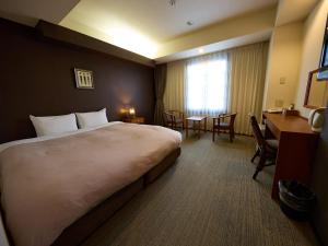 a hotel room with a large bed and a desk at Nikko Station Hotel Classic in Nikko +150 photos