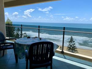 a dining room with a table and a view of the ocean at High Level with Ocean Views Everywhere in Buddina