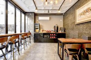 a restaurant with a bar with wooden tables and chairs at S One Hotel in Busan
