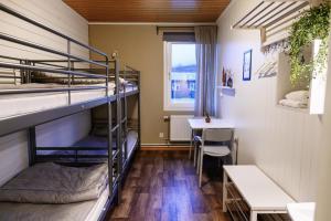 a room with two bunk beds and a table at Hemavans Fjällcenter in Hemavan +59 photos