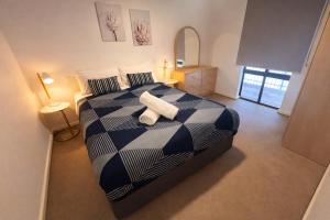 a bedroom with a bed with two towels on it at West Beach Lagoon 206 Ground Floor 2mins beach in Perth +45 photos