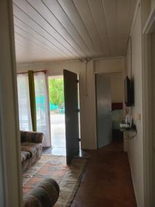 a living room with a couch and a sliding door at Don José in Los Molles