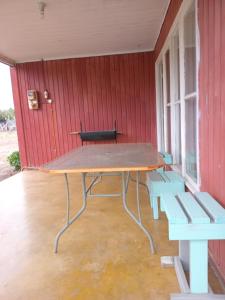 a picnic table in a room with two benches at Don José in Los Molles +12 photos