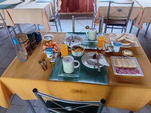 a table with food and drinks on top of it at Hostal Verde Vida in Futrono