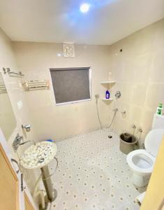 a bathroom with a sink and a toilet in a room at Al Jalal Resort in Srinagar