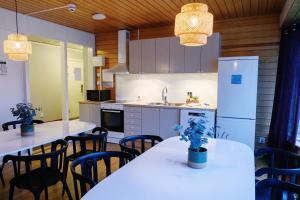 a kitchen with tables and chairs and a refrigerator at Hemavans Fjällcenter in Hemavan