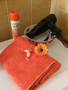 a red towel with a sunflower on top of a counter at La casa di Johnny e Valentina in Milan