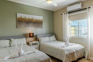 a bedroom with two beds and a window at Corte Sea A302, Luxury Penthouse in Punta Cana +40 photos