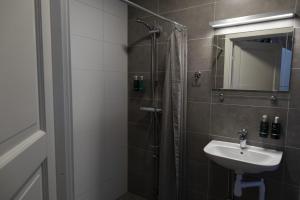 a bathroom with a shower and a sink at Hemavans Wärdshus in Hemavan