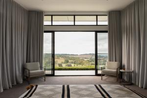a room with two chairs and a large window at Beechmont Estate in Beechmont