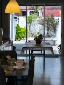 a dining room table with a view of a patio at Merdeka One Homestay 8pax 4Rooms in Sibu