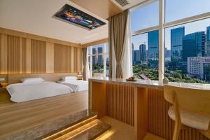 a hotel room with two beds and a large window at 苏州奇遇派东方庭院Qiyupai Eastern Courtyard Hotel in Suzhou +140 photos