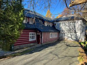 a red and white house with a red garage at Rychtrova bouda Benecko in Benecko +13 photos