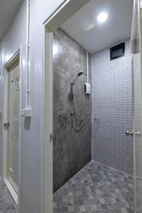 a bathroom with a shower with a glass door at BED Friends Poshtel in Chiang Rai +60 photos
