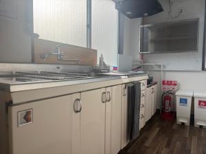 a kitchen with a sink and a counter top at とまるん桜山 in Nagoya