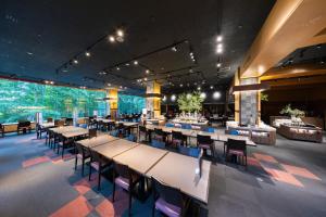 a large dining room with tables and chairs at Hotel Kanronomori in Niseko