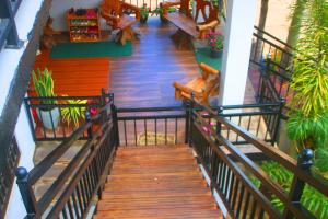 a wooden staircase with benches and plants in a building at Horton Grand Boralanda in Haputale +13 photos